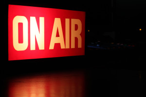 On-Air studio sign glowing with red reflection and copy space.